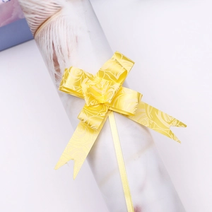 Detail of yellow gift bow with embossed rose patterns for festive gift packaging