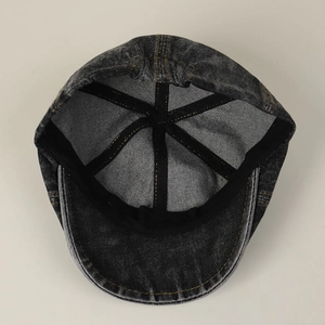 Vintage washed denim flat cap showing premium interior stitching and sweatband