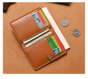 Flat lay of a brown lychee pattern leather wallet showing card slots and snap closure