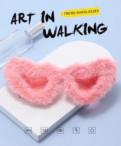 Detailed macro view of pink fuzzy heart-shaped sunglasses with plush faux fur texture