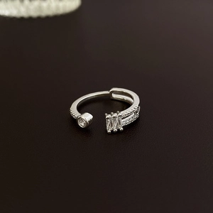 Macro shot of silver adjustable open ring with square and round zircon stone inlay
