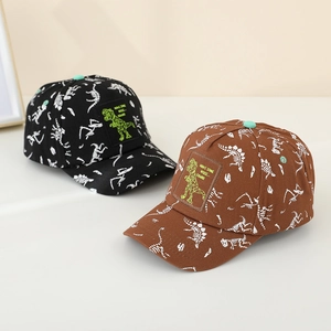 Detail of cartoon dinosaur skeleton print and embroidered patch on kids baseball caps