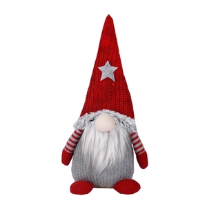 Gnomo di Natale in peluche con cappello rosso a stella e barba bianca su sfondo bianco