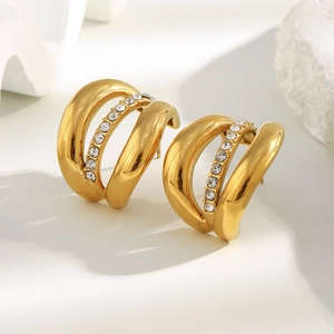 Macro shot of 18K gold plated triple layered earrings with white cubic zirconia crystals