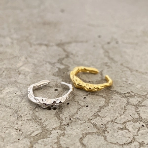 Detailed view of S925 silver ear cuffs with irregular lava texture in gold and silver