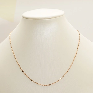 Minimalist rose gold stainless steel clavicle chain necklace on jewelry display