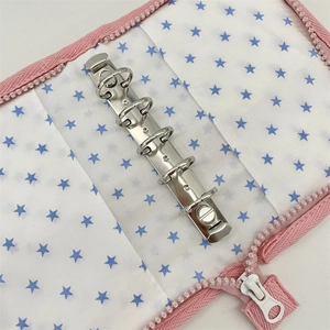 Interior view of 6-ring fabric binder with zipper and blue star pattern lining