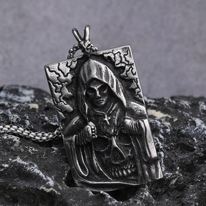 Retro stainless steel Grim Reaper skull pendant necklace on a dark stone background