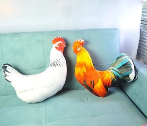Realistic digital print rooster and hen plush pillows on a light blue sofa seat