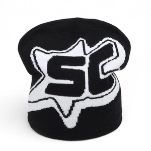Detailed close-up of a black knit beanie featuring a white SC fox head jacquard pattern