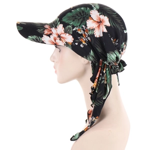 Detail view of floral print turban cap with brim and adjustable strap closure