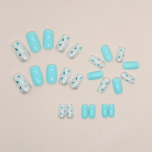 Sky blue and white gradient press-on nails with floral patterns and silver glitter detail