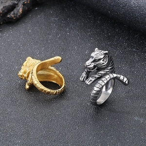 Close-up of punk style tiger head rings in gold and silver finish with detailed relief