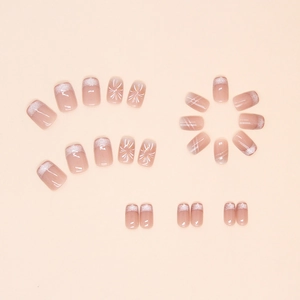 Detailed flat lay of cat-eye firework press-on nails with white French tips and star patterns