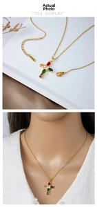 Detail of gold cross necklace with colorful gemstones and adjustable chain length