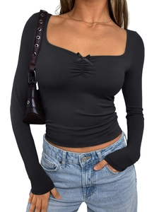 Detail of slim-fit black long sleeve top featuring a chic square neckline and bow decoration