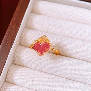 Close-up of vintage gold-plated ring with diamond-set rhombus pattern in a jewelry box
