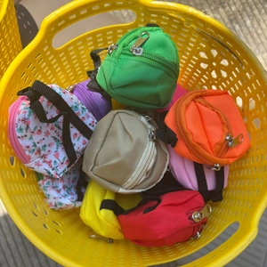 Close-up of colorful mini backpack coin purses in assorted patterns and nylon fabrics