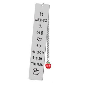 Detail of silver stainless steel bookmark with engraved quote and red apple charm