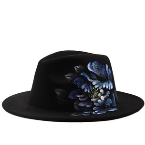 Detail of blue floral hand-painted pattern on black wool felt fedora with flat brim