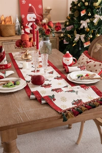 Close-up of festive jacquard Christmas table runner with tassels and reindeer patterns