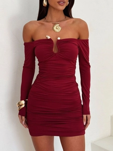 Detail of burgundy ruched bodycon dress with off-shoulder neckline and pearl accent