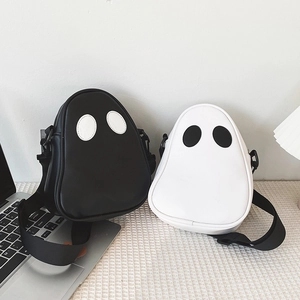 Detail shot of cute ghost-shaped PU leather crossbody bags in black and white colors