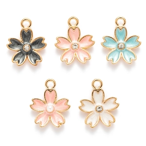 Detail view of colorful enamel cherry blossom charms with rhinestones and pearls