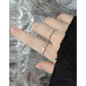 Minimalist silver beaded rings with pearl set on model in elegant aesthetic setting