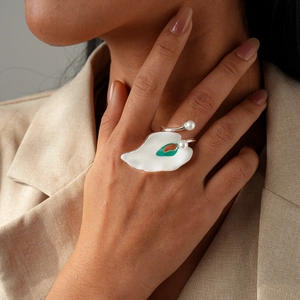 Artistic white enamel leaf ring with pearls and colorful details on model