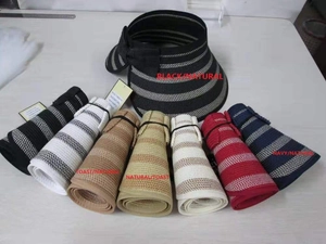 Detail of rollable straw sun visors with striped patterns and decorative bow accents