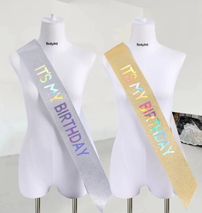 Detail of glitter birthday sash set in silver and gold with holographic text design