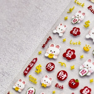 Close-up of 3D embossed nail stickers with red flowers, white rabbits and lucky charms