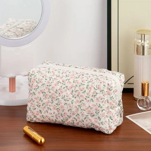 Floral quilted cosmetic bag with pink flower pattern and silver heart zipper puller