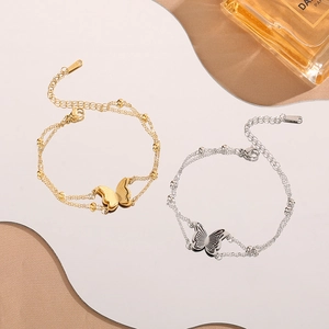Double-layered butterfly pendant bracelet in gold and silver finish for women