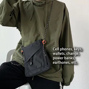 Unisex black waterproof nylon crossbody phone bag with woven shoulder strap and zipper