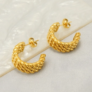 Twisted woven gold hoop earrings in stainless steel with a minimalist aesthetic for women