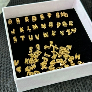 Golden 3D bubble letter beads set from A-Z with heart symbols in a white gift box