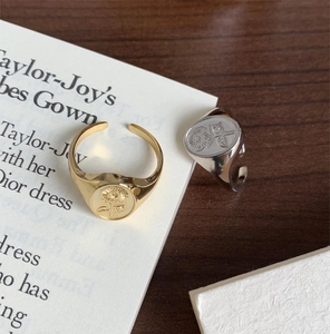 Detailed view of adjustable sunflower signet rings in gold and silver finish