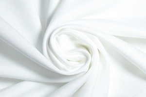Detailed macro view of white knitted fabric texture showing soft material draping