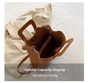Interior view of brown faux leather tote bag showing large capacity and zipper pocket
