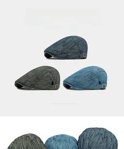 Detail of jacquard denim berets in three colors with adjustable side metal buckles