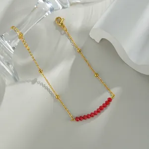 Elegant gold chain bracelet with minimalist red faceted beads and dainty golden accents