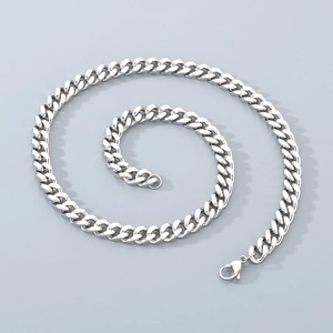 Macro view of 8mm silver punk Cuban link chain with lobster clasp and metal texture