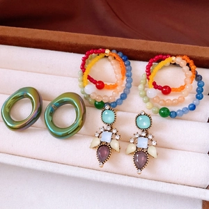 Detail view of vintage multi-style earring set with beads and rhinestones in jewelry box