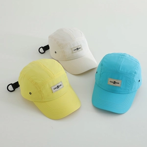 Three quick-dry 5-panel caps in yellow, white and blue with adjustable strap and metal eyelets