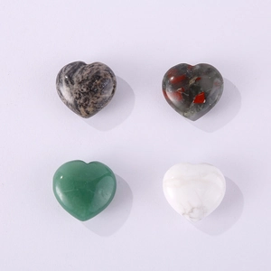 Macro shot of polished heart-shaped natural stones in marble, green, and white textures