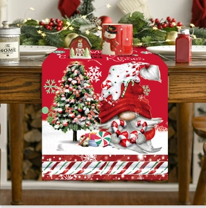 Detail of Christmas table runner with festive gnomes and candy cane kisses theme