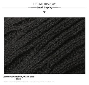 Close-up of thick black knitted fabric showing premium warmth and texture detail