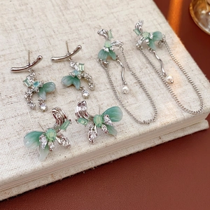 Three-piece silver bow and mint green tassel earrings with zircon and pearl accents